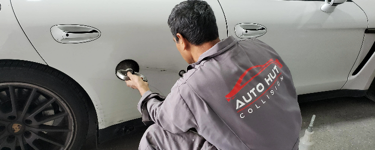 Mechanic working on auto denting and painting