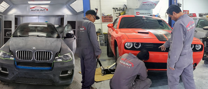 Auto Hut Tecnicians working on accidented cars BMW and Dodge
